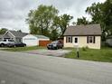 Inviting single-story home with a well-kept lawn, featuring a cozy and traditional style at 710 Bacon St, Indianapolis, IN 46227
