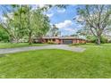 Wide view of a brick house featuring a paved driveway and well-maintained landscaping at 7380 N State Road 267, Brownsburg, IN 46112