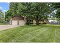 Charming home with a two-car garage, stone accents, and a well-maintained lawn at 7426 N Carroll Rd, Indianapolis, IN 46236