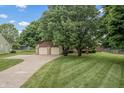 Beautiful home with a two-car garage, stone accents, and a long driveway at 7426 N Carroll Rd, Indianapolis, IN 46236