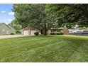 Charming home with a two-car garage, stone accents, and a lush front lawn at 7426 N Carroll Rd, Indianapolis, IN 46236