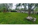 Spacious backyard featuring a swing set and room for outdoor activities, ideal for Gathering enjoyment and recreation at 7435 E 50Th St, Indianapolis, IN 46226