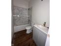 Renovated bathroom featuring marble tile, new vanity, and fixtures at 830 Villa Ave, Indianapolis, IN 46203