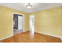 Bright dining room featuring hardwood floors, classic molding, and neutral yellow walls at 8331 Tequista Ct, Indianapolis, IN 46236