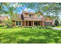 Beautiful two-story home featuring brick and siding, a manicured lawn, and an attached garage at 8331 Tequista Ct, Indianapolis, IN 46236
