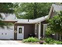 Side view of home with garage and garden with flowers at 8373 W State Road 47, Thorntown, IN 46071