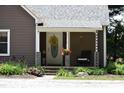 Inviting front porch of home with decorative door and landscaping at 8373 W State Road 47, Thorntown, IN 46071