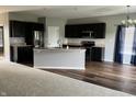 Modern kitchen featuring dark cabinetry, granite countertops, stainless appliances and open-concept design at 842 Westpointe Dr, Shelbyville, IN 46176