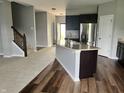 Bright kitchen with dark cabinetry, granite countertops, stainless appliances and an island at 842 Westpointe Dr, Shelbyville, IN 46176
