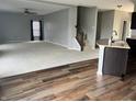 Open-concept living room next to an eat-in kitchen and featuring modern finishes and a staircase to the second floor at 842 Westpointe Dr, Shelbyville, IN 46176