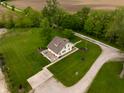 Picturesque property featuring a charming home with well-manicured lawn and a serene driveway at 8468 S County Road 575 E, Mooresville, IN 46158