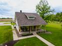 Charming home featuring a cozy front porch with stone accents and a meticulously maintained lawn at 8468 S County Road 575 E, Mooresville, IN 46158
