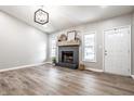 Open-concept living area with a modern fireplace, bright windows, and laminate flooring at 912 Delray Dr, Indianapolis, IN 46241
