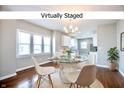 Virtually staged dining area featuring natural light, modern chandelier, and an open concept at 920 E Tabor St, Indianapolis, IN 46203