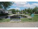 Neighborhood pond with bench and rules signage at 9774 Foxboro Ln, Fishers, IN 46038