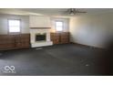 Large living room featuring a fireplace, built-in shelving, and two large windows at 1045 Springway Dr, Shelbyville, IN 46176