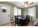 Well-lit dining room featuring a dark wood table, matching chairs, and a ceiling fan at 11720 S County Road 396 E, Muncie, IN 47302