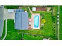 Aerial view of a backyard featuring a private pool, lush green lawn, and a well-maintained wooden fence at 1199 Oak Leaf Rd, Franklin, IN 46131