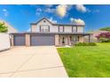 Beautiful two-story home featuring a three-car garage, manicured lawn, and well-maintained landscaping at 1199 Oak Leaf Rd, Franklin, IN 46131