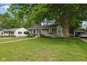 Quaint home with lush lawn, mature tree, and inviting curb appeal in a quiet neighborhood at 1240 Hamilton Dr, Noblesville, IN 46060