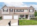 Beautiful two-story home boasts a well-kept lawn and classic architectural details at 12994 Dekoven Dr, Fishers, IN 46037