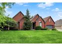 Beautiful single-Gathering home with a manicured lawn, mature landscaping, and a brick facade under a sunny sky at 14492 Allison Dr, Carmel, IN 46033