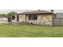 Stone home with a well-maintained lawn and landscape, offering curb appeal at 1601 Southern Ave, Beech Grove, IN 46107