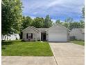 Inviting front exterior with lush green lawn and attached two-car garage at 167 Hilltop Farms Blvd, New Whiteland, IN 46184