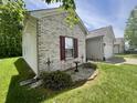 Side exterior showcasing the nice yard, with well-maintained landscaping around the home at 167 Hilltop Farms Blvd, New Whiteland, IN 46184