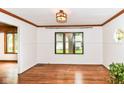 Bright living room with hardwood floors, white walls, and natural light from large windows at 1841 New St, Indianapolis, IN 46203