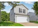 Charming two-story home featuring an attached garage and classic curb appeal at 1936 Southernwood Ln, Indianapolis, IN 46231