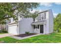 Charming two-story home featuring an attached garage and classic curb appeal at 1936 Southernwood Ln, Indianapolis, IN 46231
