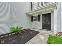 Inviting front entrance with a dark door and landscaped area at 1936 Southernwood Ln, Indianapolis, IN 46231