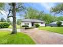 Inviting single-story home with manicured lawn, mature trees, and a private driveway at 2105 Mayfair Dr, Indianapolis, IN 46260