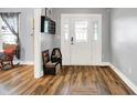 Bright foyer featuring hardwood floors and a white front door with decorative glass at 241 N Liberty Blvd, Mooresville, IN 46158