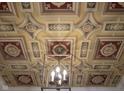 Ornate ceiling with decorative molding and a stylish light fixture, showcasing elegant architectural details at 2445 N Delaware St, Indianapolis, IN 46205