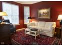 Cozy living room with a comfortable white sofa, a patterned rug, and classic decor at 2445 N Delaware St, Indianapolis, IN 46205
