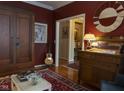 Elegant living room with hardwood floors, a decorative mirror, and a classic display case at 2445 N Delaware St, Indianapolis, IN 46205