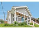 Gray home with inviting porch and updated features at 301 Leeds Ave, Indianapolis, IN 46201