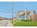 Charming gray home featuring a covered porch and a bright blue front door at 301 Leeds Ave, Indianapolis, IN 46201