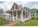 Inviting front porch features decorative columns, brick walkway, and flower baskets at 3360 Main St, Plainfield, IN 46168