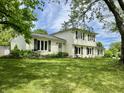 Charming two-story home with lush green lawn and mature landscaping and patio table at 377 4Th E Ct, Carmel, IN 46033