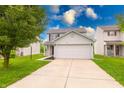 Traditional two-story home with a spacious driveway and well-maintained front lawn at 4056 Orchard Valley Ln, Indianapolis, IN 46235