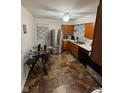 Cozy kitchen featuring stainless steel appliances, wooden cabinets, and a round glass dining table at 4113 W 30Th St, Indianapolis, IN 46222