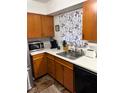 Well-lit kitchen featuring warm wood cabinets and stainless steel appliances at 4113 W 30Th St, Indianapolis, IN 46222