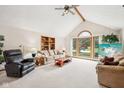 Bright living room with vaulted ceiling, large windows, and comfortable seating at 412 Sonhatsett Dr, Westfield, IN 46074