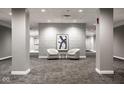 A modern hallway features neutral colors, stylish seating, and an elegant textural wall design at 435 Virginia Ave # 106, Indianapolis, IN 46203