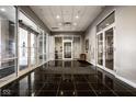 An elegant lobby with a black marble floor, multiple glass doors, and modern interior finishes at 435 Virginia Ave # 106, Indianapolis, IN 46203