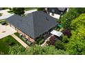 An aerial shot of the rear of the home featuring an outdoor dining area and beautifully landscaped yard at 5350 Chico Grey Dr, Indianapolis, IN 46237