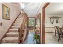 Inviting entryway with slate floors, carpeted stairs and wood trim at 577 Century Oaks Dr, Zionsville, IN 46077